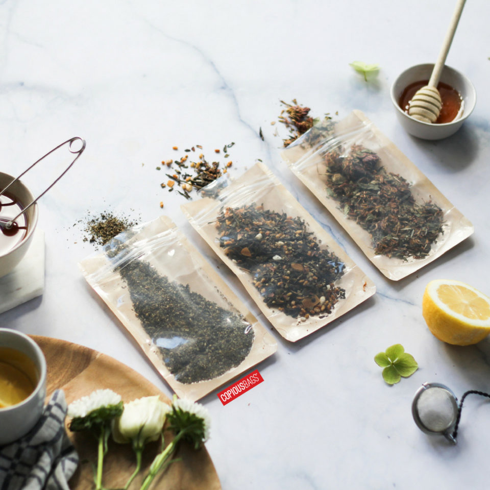 Three kraft stand up pouches containing loose tea