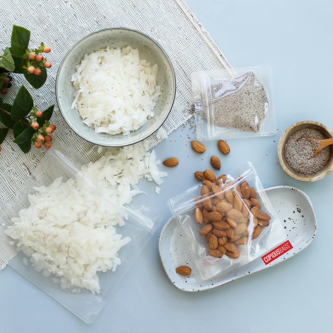 Transparent pouch with various snacks including almonds