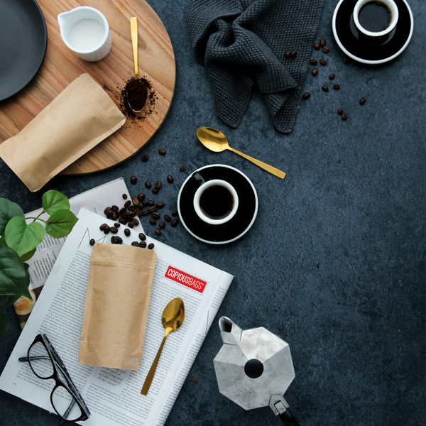 Kraft pouch next to espresso cup and coffee beans